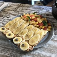Peanut butter on toast with banana on top and a fruit salad  at Cafe Secret Alley in Kandy