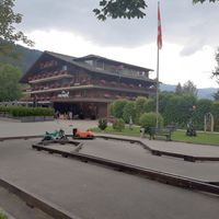 Exterior with playground at La Sarine - Hotel arc en Ciel in Gstaad