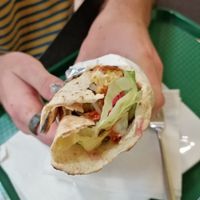 falafel wrap with hummus, tahini and hot sauce, salad at Delina's in Toronto