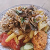 Vegan gyros made with oyster mushrooms, pita bread, hummus and fries. at Evilion Bistro in Crete