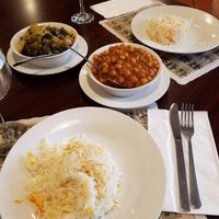 a tomato and okra curry as well as channa masala with 2 servings of seasoned basmati rice at Maurya Kebabs & Curries in Beltsville