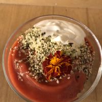Granola with vegan yogurt and puréed berries sprinkled with some kind of seed  at Sereda in Kyiv