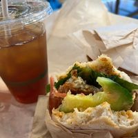 Half eaten chicken sandwich and Iced Tea. at Chef Tanya's Kitchen in Palm Springs