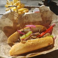 Apple sausage with mushrooms, peppers, pickled onions, apple horseradish, and fries. at King's BierHaus in Houston