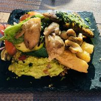 Huge super filling and delightful dish with rice, beans, peppers, mushrooms, tomatoes, chickpeas omelette, guacamole and other greens. Beautiful 😋  at Andino Gastrobar in Malaga