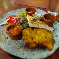 Plato centroamericano with marinated sautéed tofu and lots of black beans and rice, fried plantain and sauces at Andino Gastrobar in Malaga