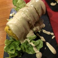 Corn on the cob drenched in sauce.. ask for the vegan menu when ordering  at Andino Gastrobar in Malaga