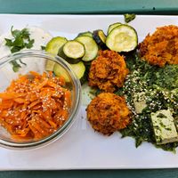 Rice-bulgur balls, spinach-tofu stir-fry, oven-baked zucchini, herb dip, carrot salad at Dreizehn in der Muehle in Augsburg