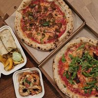 The pizzas are not from VegMachine. Loved the lovely Caesar wrap with best fries ever and the onion rings! at Veg Machine in Tallinn