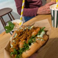 Pulled sweet potato burger with shake in background at Veg Machine in Tallinn