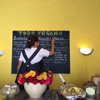 Flora writing today's menu at Loving Hut - San Cristobal in San Cristobal De Las Casas