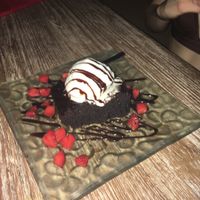 Amazing Vegan Brownie with coconut ice cream, chocolate sauce and strawberries! at Clear Cafe in Ubud