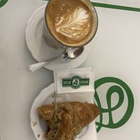 Coffee with soy milk and croissant with jam  at Dolce Pisa in Pisa