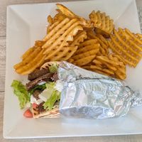 Gyro with seasoned waffle fries at Simply Green Cafe in Ramsey
