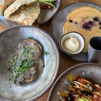 Breakfast quesadilla, biscuits & gravy, breakfast potatoes, and blueberry pancakes at Bearcat Cafe - Uptown in New Orleans
