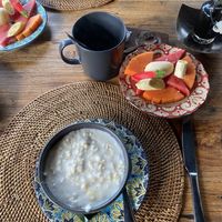 Breakfast-oat porridge with coconut cream, fruits, coffee  at Sarinbuana Eco Lodge Restaurant in Tabanan