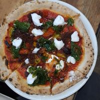 Pizza with vegan cheese at Tarifa EcoCenter in Tarifa