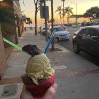 Pistacio and chocolate with a seasonal fudgey flavor on top  at Dolce Gelato in Laguna Beach