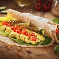 Hummus Wrap - home made hummus with lots of spices, with pickles, tomatoes, lettuce and a sourdough flat bread
 at Sara Green - Vegan Bistro in Bucharest