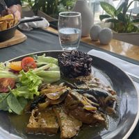 Saitan-Steak (homemade) with black risotto rice   at Lusitania in Alvor