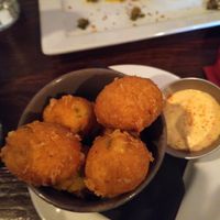 jalepeno hush puppies with mushroom scallops in background at Harmonium in Edinburgh