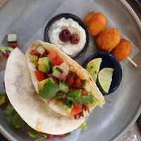 Tacos with BBQ "meat", avocado, salad, and rice cheddar croquettes at Happy Bean in Prague