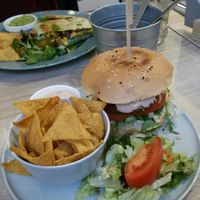 "Meat" burger with vegan cheese and nachos at Happy Bean in Prague
