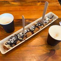 Vegan pancake with apple and chocolate sauce and 2 cappuccino with oat milkk  at The Happy Pig Pancake Shop in Amsterdam