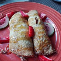 Pancakes with a banana, nut filling and strawberries. at The Secret Garden in Benoni