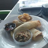 Pancakes with walnuts, maple syrup, and bananas at The Secret Garden in Benoni