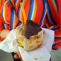 Three scoops of vegan ice cream in a brioche bun at Al Gelatone in Palermo