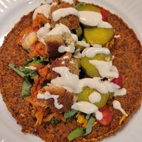 The raw wrap, falafel, tahini, and nuts for cheese were bought here. I took it home to assemble. at The Wooden Spoon Bakery in Leamington