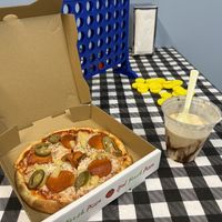 Pineapple, pepperoni, and jalapeño pizza ands peanut butter shake. Newly added tables in the back with games to play.  at Food Fight Vegan Grocery - Halsey St in Portland