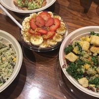 smoothie bowl in center, salad, and avocado toast at Upbeet in Atlanta