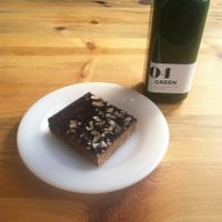Raw bar made out of figs, walnuts, orange, coconut, with a  chocolate layer on top

Green Juice 04: spinach, strawberries, celery, lemon, and apple at Unbakery and Juicery in Kansas City