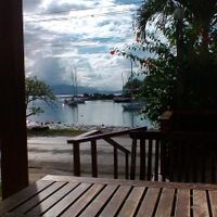 Beautiful view from the tables out front. Boats in the harbor and Nawi Island.  at Grace Road Kitchen in Savusavu
