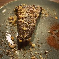 Cake Raw Ganache de Cacau base de tâmaras, castanhas e Farofa de Avelã  at Raw Porto Alegre in Porto Alegre