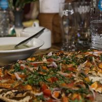 Vegetarian pizza ( with no cheese) and a quinoa soup.  at Ulrike's Cafe in Calca