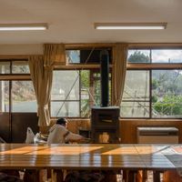 Light interior with multiple long tables perfect for groups at Sansankan in Minamisanriku