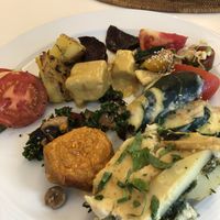 Delicious plate of hot foods and salads at The Sacred in Zurich