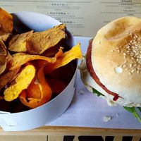 Vegan burger, tofu, tomato & rocket salad and sweet potato fries with vinaigrette sauce at Gutsy in Carcavelos