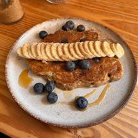 Pancakes 🥞 with blueberries 🫐 , bananas 🍌 and agave syrup   at Goldig in Lagos