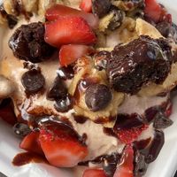 Chocolate frosting, cookie dough, chocolate chips, chafe sauce, and strawberries    at Cinnaholic in Los Angeles