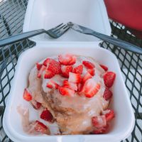 bun with chocolate sauce & strawberries  at Cinnaholic in Los Angeles