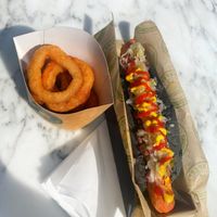 Vegan hotdog en onion rings  at Vburger Camden in North West London