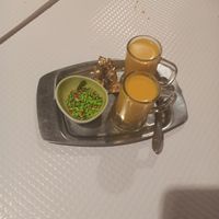 Mango lassi they serve after the meal, when you order the bill. Very tasty, made with coconut milk. The bowl on the side is filled with some kind of candy, made with spices.
 at Sanskar Nepal in Lisbon