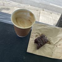 Coffee on the go! Oat Latte and a vegan brownie.   at My Village Hawraman Cafe in North West London
