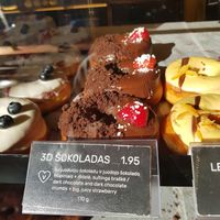 THIS IS THE BEST DOUGHNUT ❤️ dark chocolate with strawberry, those crumbs are amazing! at Holy Donut - Vokiečių in Vilnius