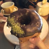 Vegan donut with dark chocolate and pistachios at Holy Donut - Vokiečių in Vilnius