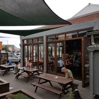 Outdoor seating with grassy spots at Addington Coffee Co-op in Christchurch